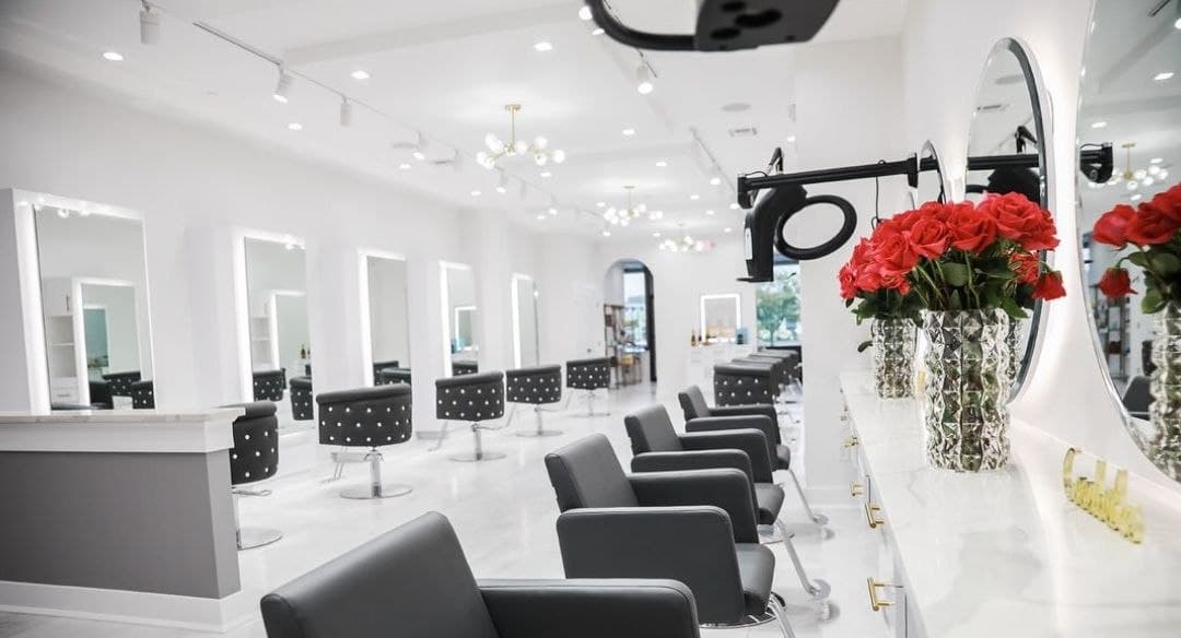 Salon floor with styling chairs, mirrors, and roses